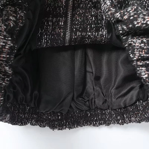 Detail of black tweed bomber jacket with metallic threads and quality inner lining