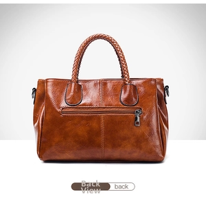 Detail view of brown oil wax leather Boston bag back featuring metal zipper pocket