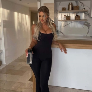 Detailed view of the sleek black high-elastic backless yoga jumpsuit with flared legs