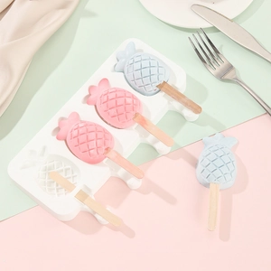 Detailed view of pineapple-shaped silicone ice cream mold with colorful homemade popsicles