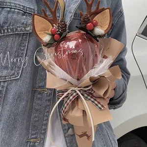 Handmade Christmas bouquet with brown reindeer antlers, red apple and pine cones decoration