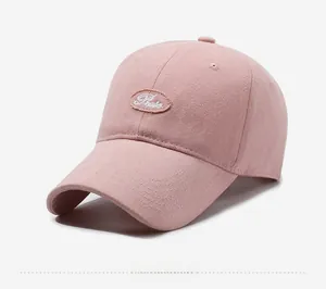 Detail view showing pink cotton baseball cap with Prete embroidery and curved brim