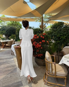 Back view of elegant white two-piece set with puff sleeves and long skirt for summer