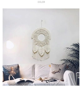 Detailed view of woven leaf macrame wall hanging with off-white cotton tassels