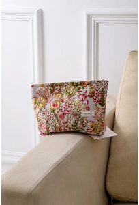 Close-up of vintage floral jacquard makeup bag with HER BAG label on a soft beige sofa