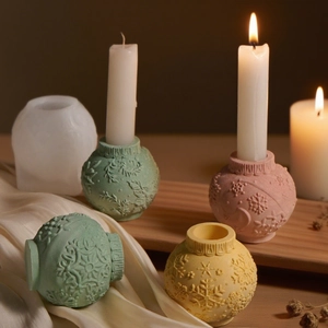 Macro shot of 3D snowflake embossed candle holder resin molds and finished plaster spheres