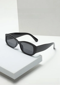 Close-up of black square frame sunglasses with dark UV lenses on geometric blocks