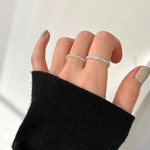 Detail of S925 sterling silver slim ring featuring a continuous row of sparkling zircons