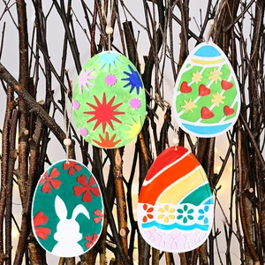 Easter egg pendant ornaments featuring bunny and heart designs on rustic wood branches