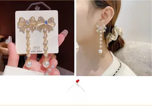Detail of luxury bow earrings with tassel pearls and sparkling crystal stud for women