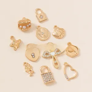 Detailed assortment of gold plated DIY charms including stars and shells with rhinestones