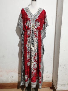 Detailed view of bohemian floral print dress with V-neckline and tassel waist drawstring