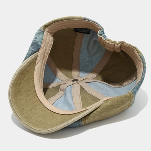 Interior view of vintage cotton newsboy cap with patchwork design and adjustable strap
