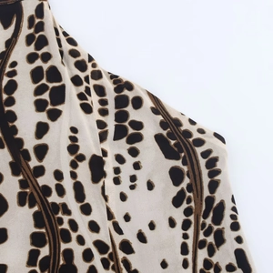 Close-up of leopard print chiffon fabric with soft texture on a halter neck dress