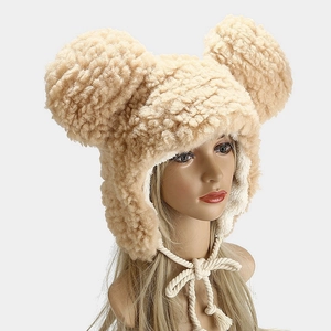 Beige lamb wool winter hat with large cute ears and warm earflaps with tassels
