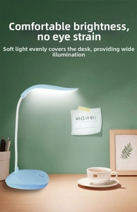 Detail of light blue flexible LED desk lamp with adjustable neck and touch base on table