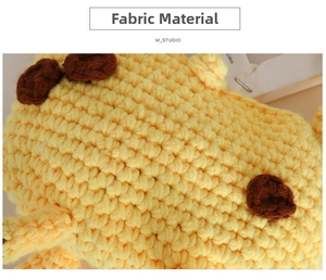 Detail of hand-knitted giraffe bag showing yellow crochet fabric and brown spot texture