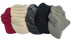 Flat lay of five chunky knit visor beanies in assorted colors for winter warmth