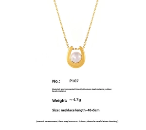 Detail view of gold titanium steel horseshoe pendant necklace with faux pearl inlay