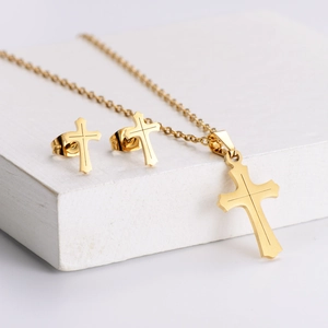 Golden titanium steel cross jewelry set featuring a pendant necklace and stud earrings