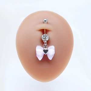 Detailed close-up of a silver belly ring with a purple bow and black heart charm