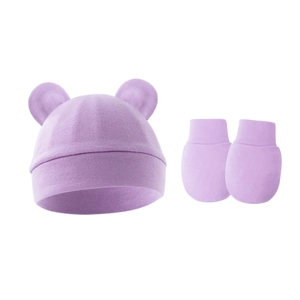 Close-up of lavender knit newborn hat with round ears and matching mittens set
