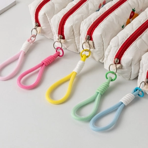 Detailed view of quilted fabric pencil cases with heart patterns and colorful zipper pulls