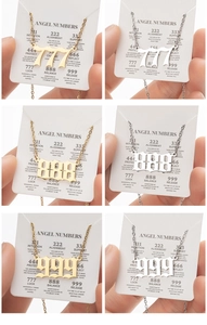 Detail of 777, 888 and 999 angel number necklaces in gold and silver gothic fonts