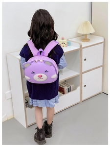 Close-up of a purple 3D cartoon bear backpack with adjustable straps for kids