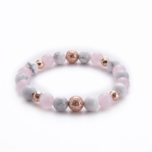Macro detail of 8mm rose quartz and white howlite yoga beads with rose gold accents