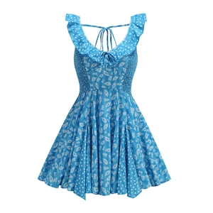 Detail of floral and polka dot patchwork on blue summer dress with ruffle V-neckline