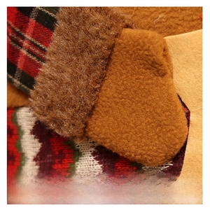 Macro detail of Christmas chair cover showing plush brown fabric and classic plaid patterns
