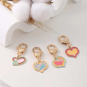 Detail of colorful enamel heart charms with lobster clasps for DIY jewelry making