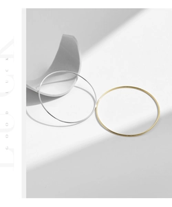 Detail of minimalist S925 sterling silver ultra-thin rings in gold and silver finishes