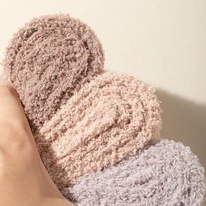Thick coral fleece over-knee socks in brown pink and grey showing soft fluffy texture