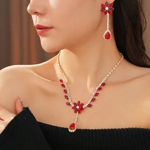 Luxury gold jewelry set featuring red zircon flower necklace and matching drop earrings