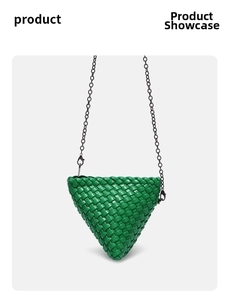 Detail of woven triangular bag in bright green leather with black metal chain strap
