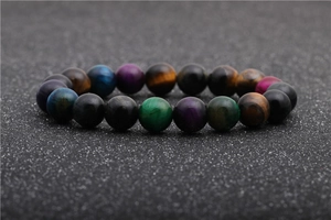Macro shot of colorful tiger eye stone beads with natural cat eye texture on elastic bracelet