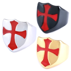 Detailed close-up of shield-shaped knight rings with red cross inlay in three metal colors