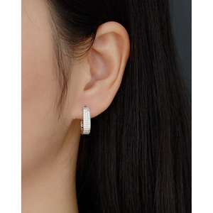 Close-up of S925 silver U-shaped earrings with micro-pave cubic zirconia on model