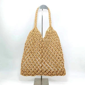 Detail of khaki woven cotton rope tote bag showing sturdy braided handles and mesh design
