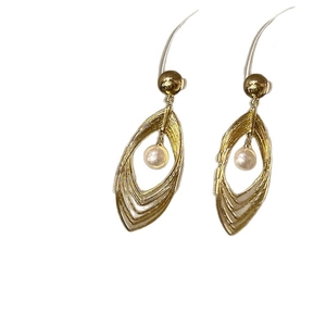Modern layered hollow teardrop earrings in gold metal with a single white pearl accent