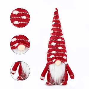 Detailed knit texture and plush beard of a festive red and white Christmas gnome ornament