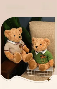 Detail of cute teddy bears wearing knit sweaters with metal chain pins and embroidery