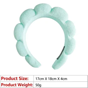 Detail view of light green puffy spa headband showing 17x18x4cm dimensions and soft texture