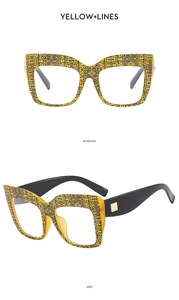 Detail of square yellow and black patterned frames with gold studs on the side