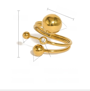Detailed view of gold spiral ring with dimensions of metal spheres and crystal inlay