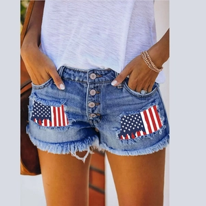 Women's distressed denim shorts with American flag print and frayed hems in light blue