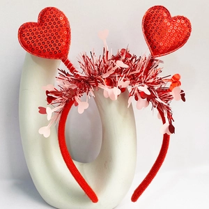 Detail of red sequin hearts and pink fringe charms on a Valentine's Day headband