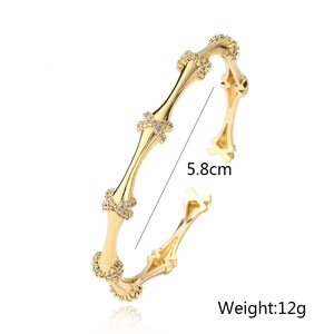 Detailed view of gold bamboo bone bangle with zircon pavé showing 5.8cm inner diameter